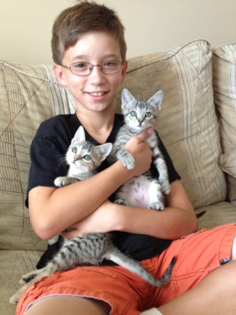 Alex with Zeus and Athena on adoption day.